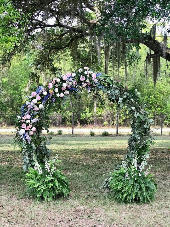 Half Circle Arch with Fern encased in flowers and greenery