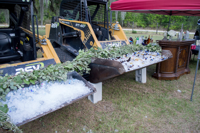 Skid Steers used as Coolers and Draped Greenery